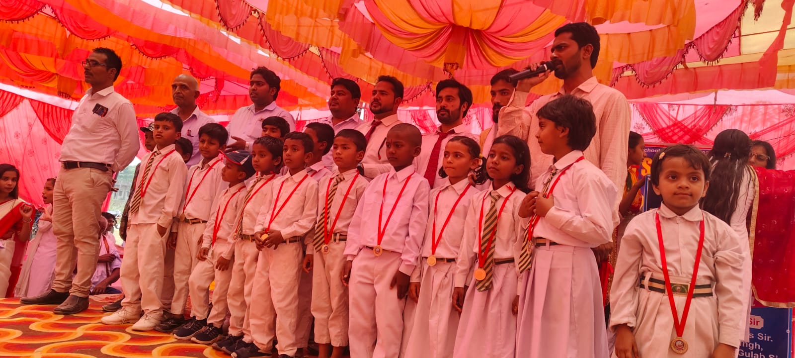 Annual Day - Students receiving medals on stage